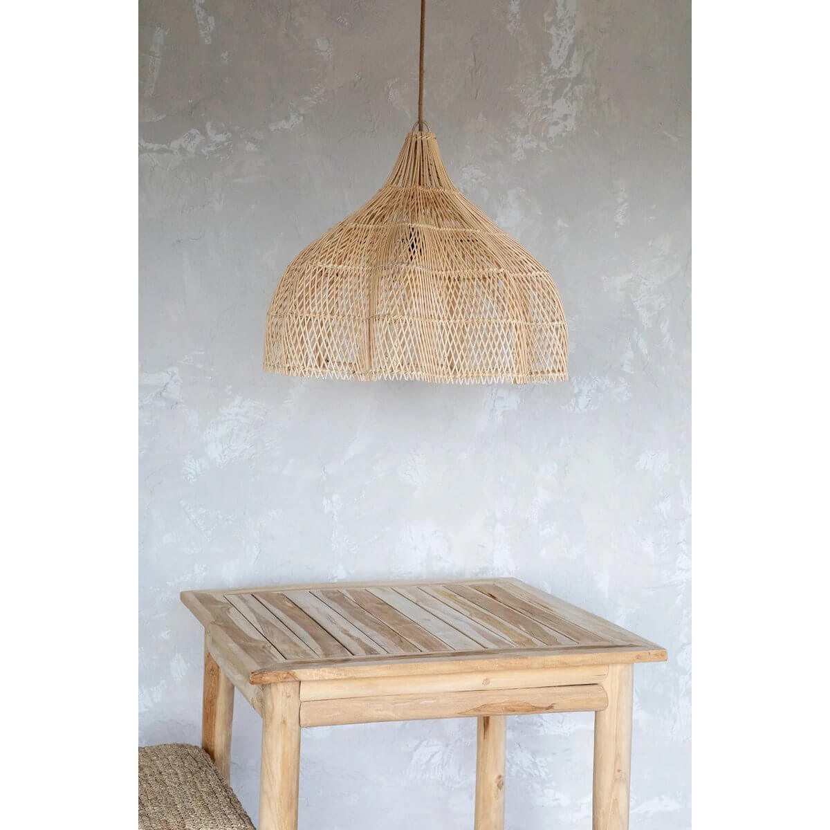 Bohemian rattan hanging lamp with unique design over wooden table, perfect for indoor and outdoor decor.