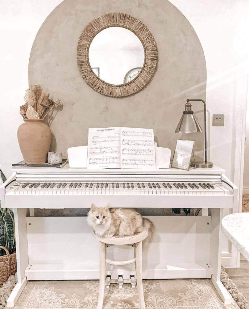 Katten voor piano met Boho spiegel The Tahiti, met Indonesische raffia, die een etnische en boho sfeer aan het interieur toevoegt.