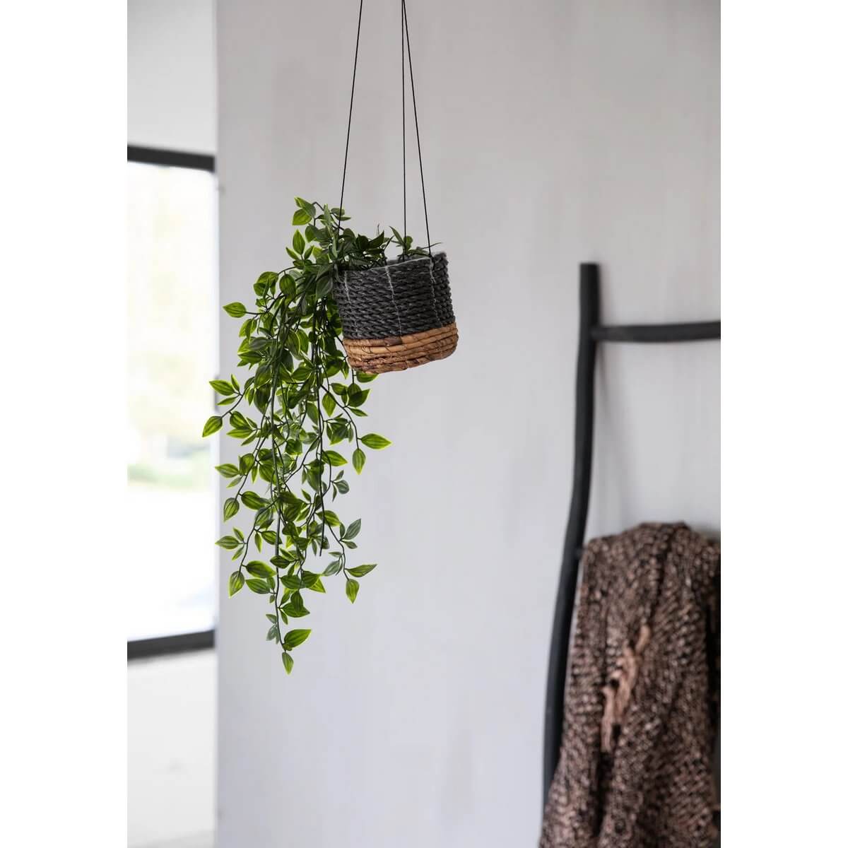 Bohemian hanging basket in natural black, crafted from banana leaf and seagrass, showcasing lush greenery, perfect for home decor.