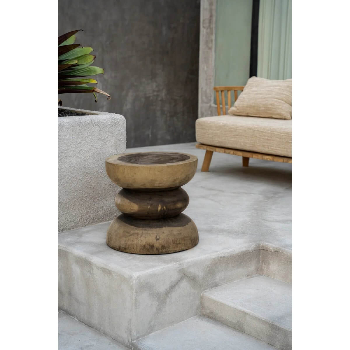 Bohemian De Corfu-kruk in natural setting, handmade from Mungurr wood, ideal for living rooms, bathrooms, or as a garden accent.