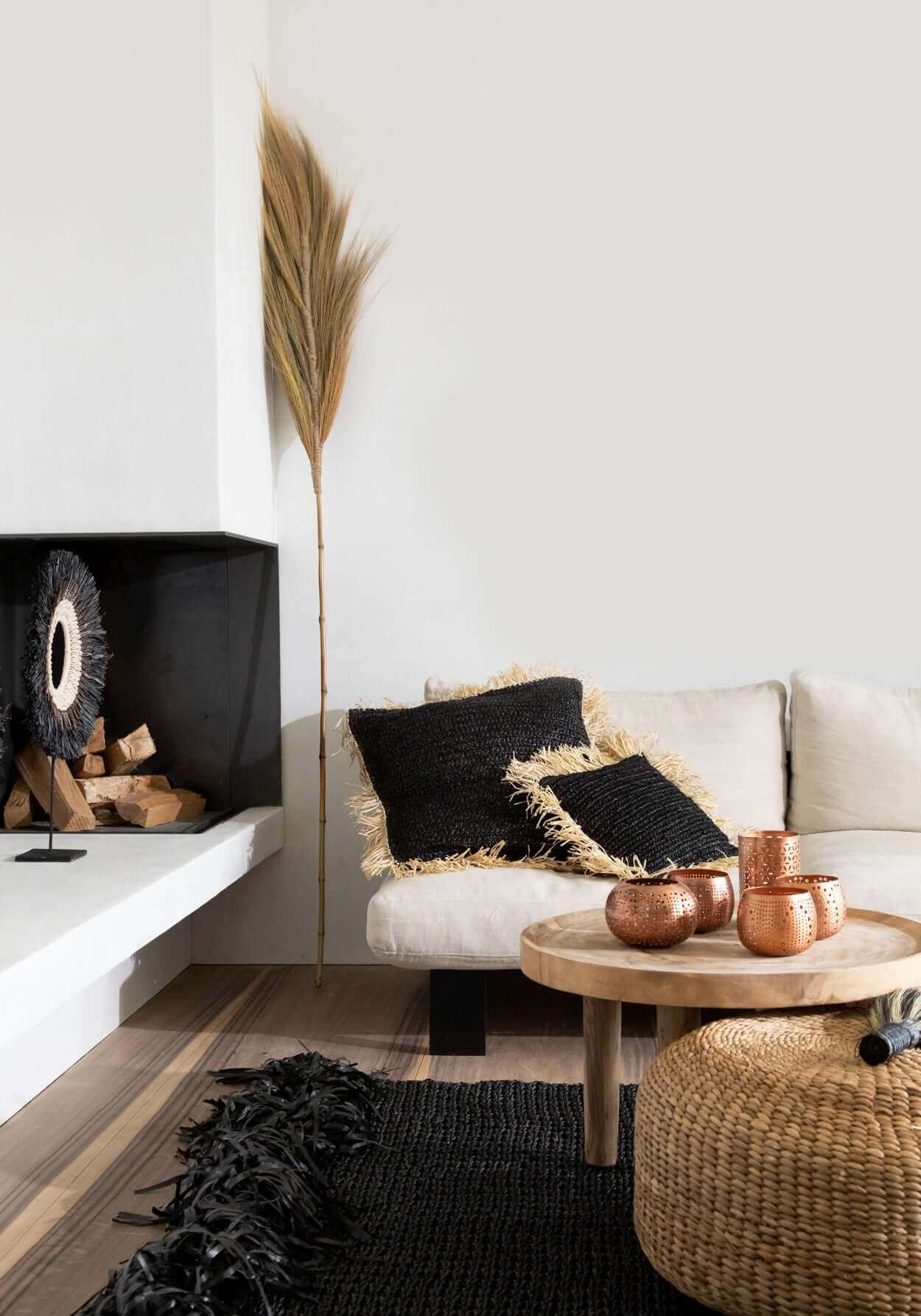 Gezellige woonkamer met De Hyacinth Poef, kussen, en landelijke decoratie, perfect voor een boho sfeer in huis of tuin.