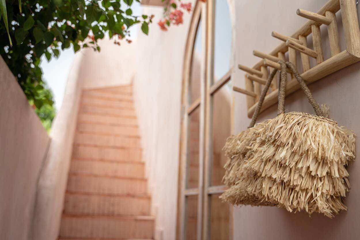 Natuurlijk massief teakhouten kapstok met decoratieve uitstraling aan een muur bij een trap, perfect voor hal of badkamer.