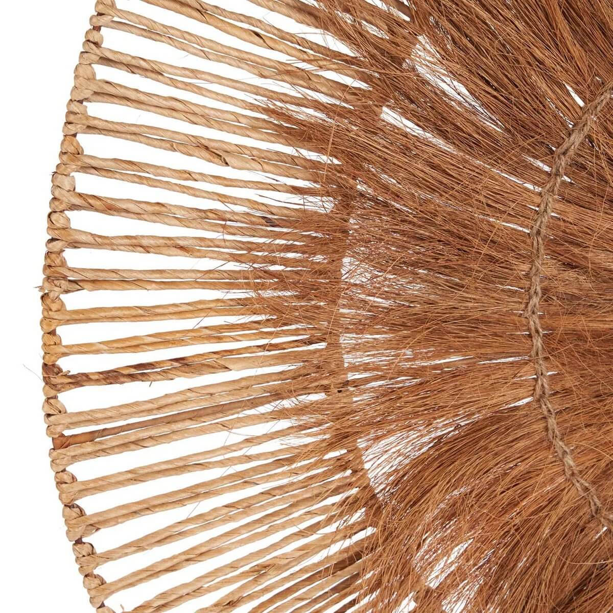 Close-up of handcrafted Lobo wall decor made from banana leaf and coconut, showcasing bohemian style and intricate natural textures.