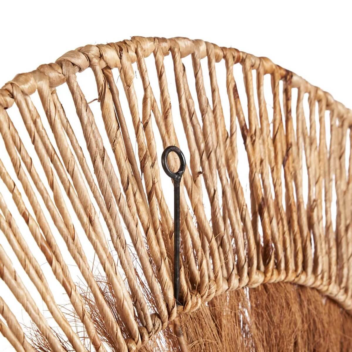 Close-up of handcrafted Lobo wall decor made from banana leaf and coconut, showcasing Bohemian style with intricate natural textures.