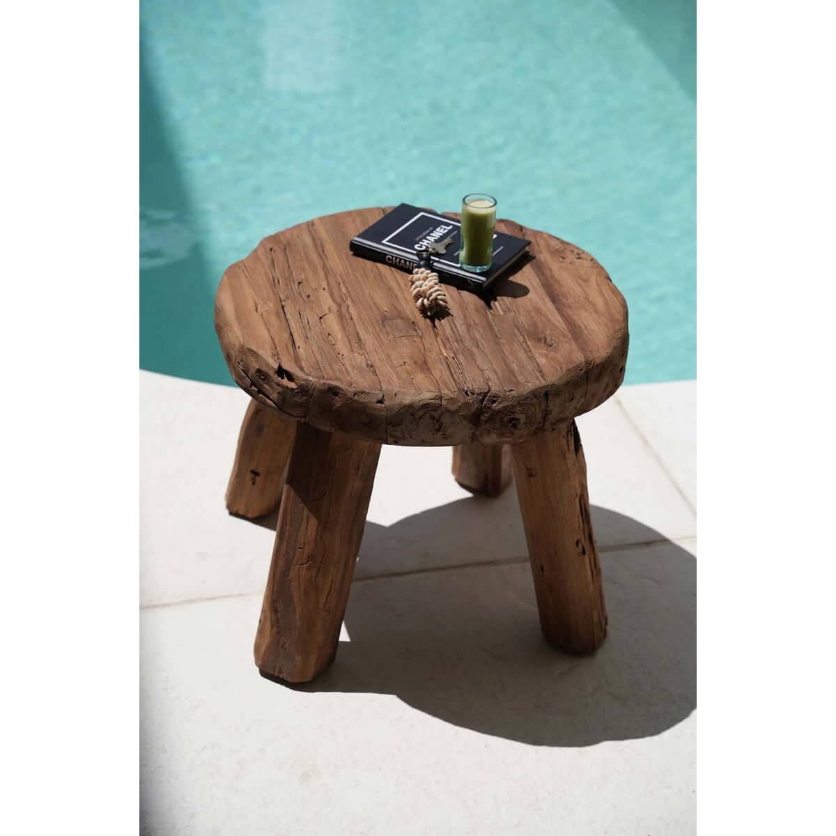 Bohemian rustic side table by the pool, showcasing earthy design with natural wood finish. Perfect for cozy, nature-inspired spaces.