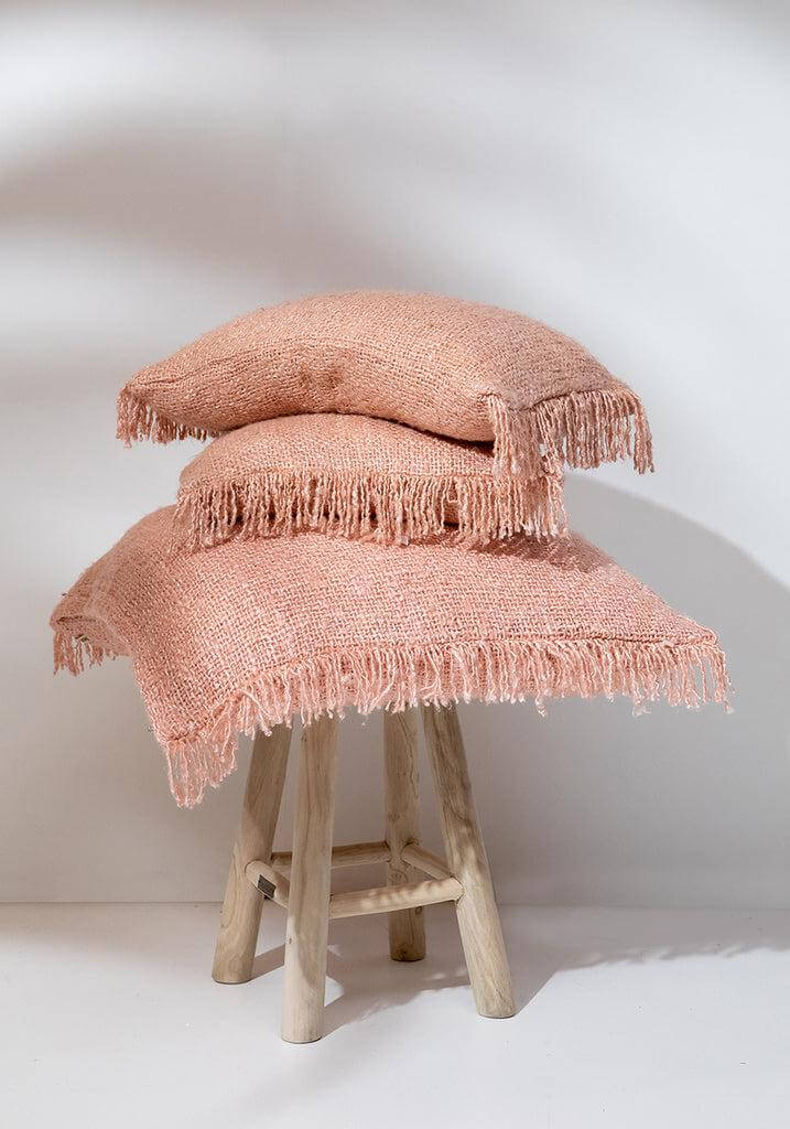 Zalmroze boho kussenhoezen van zacht katoen, 60x60 cm, op houten krukje. Ideaal voor een chique en stijlvolle interieurlook. Geen binnenkussen inbegrepen.