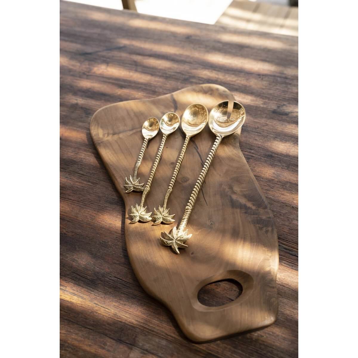 Luxurious gold palm tree spoons in Bohemian style, crafted from solid brass, beautifully placed on a wooden board.