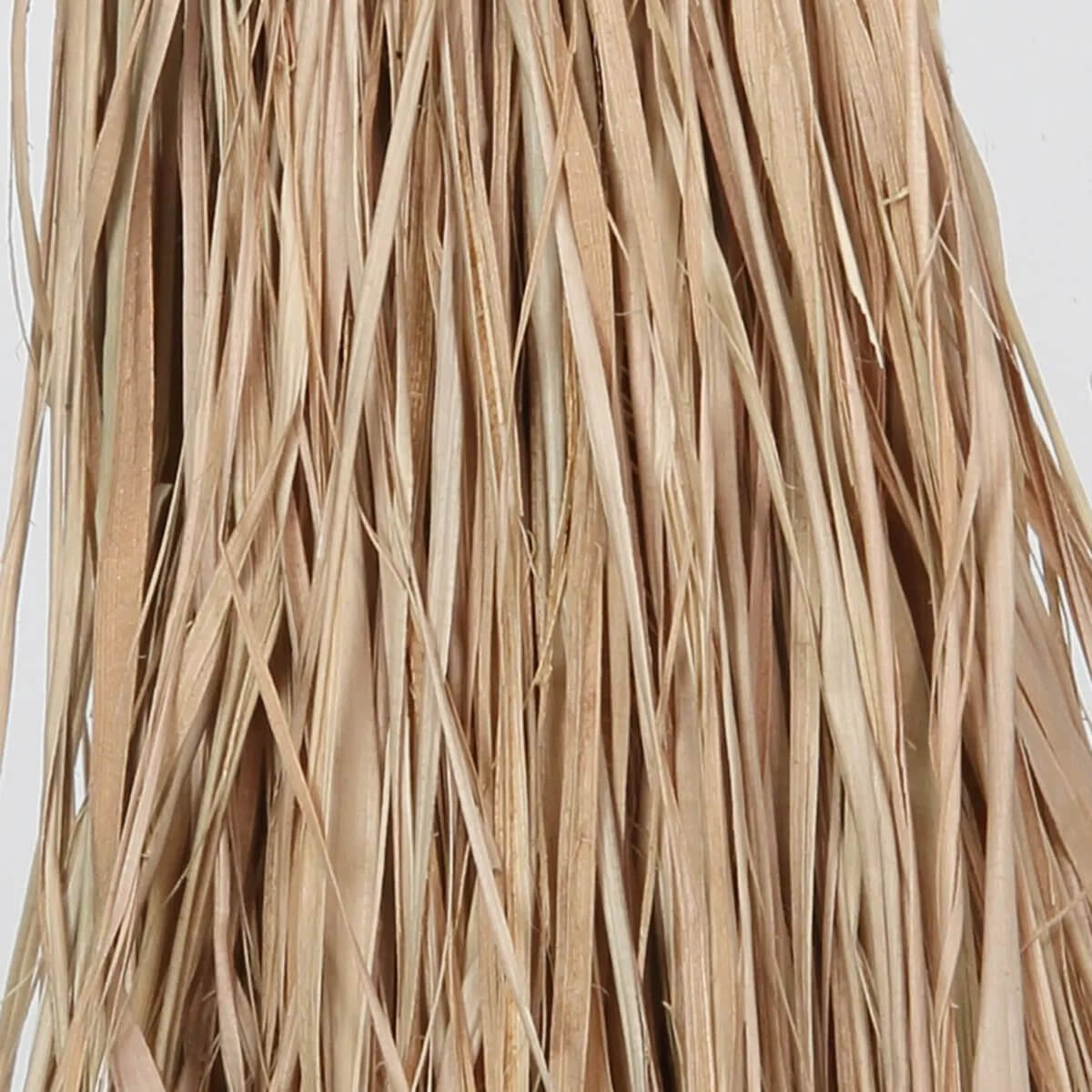 Close-up of beige raffia strands, highlighting the natural texture and bohemian style of handcrafted decor elements.