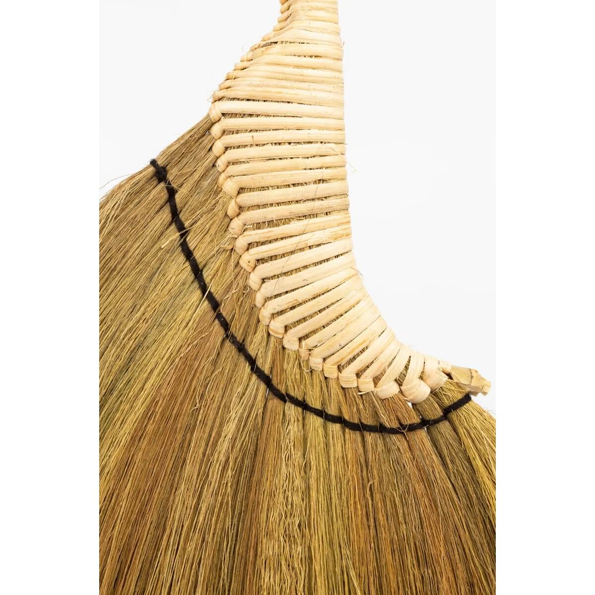 Close-up of handwoven Indonesian Bohemian broom with natural fibers, showcasing intricate decorative design and hanging cord detail.