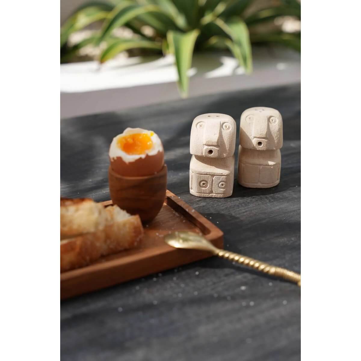 Bohemian-style Salt & Pepper Sumba shakers made of sandstone, crafted as charming stone men, adding artistic flair to your table.