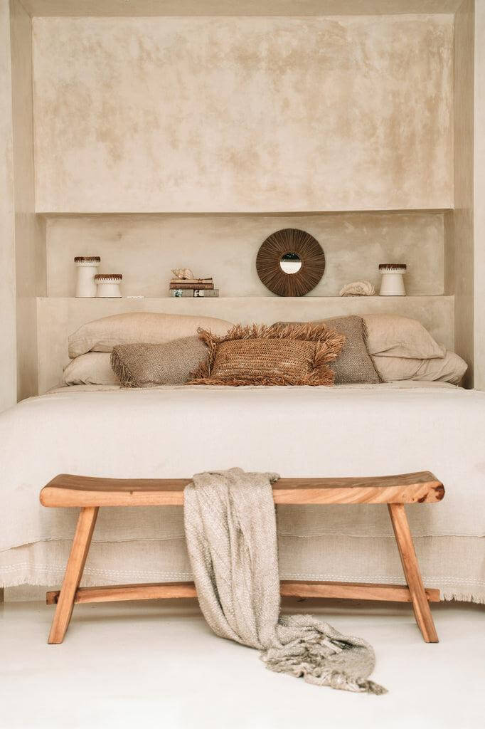 Prachtige beige plaid voegt warmte en stijl toe aan een gezellige slaapkamer met houten bankje. Perfect voor comfort en interieurdecoratie.