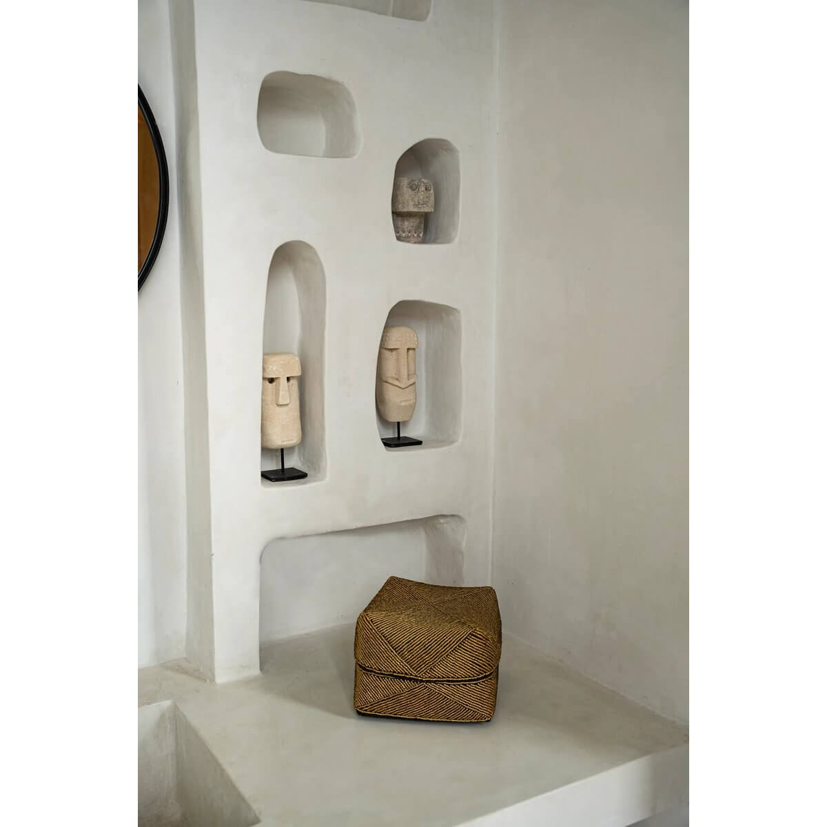 Bohemian decor with Sumba stone statues on a textured shelf, showcasing hand-carved artistry from Indonesia.