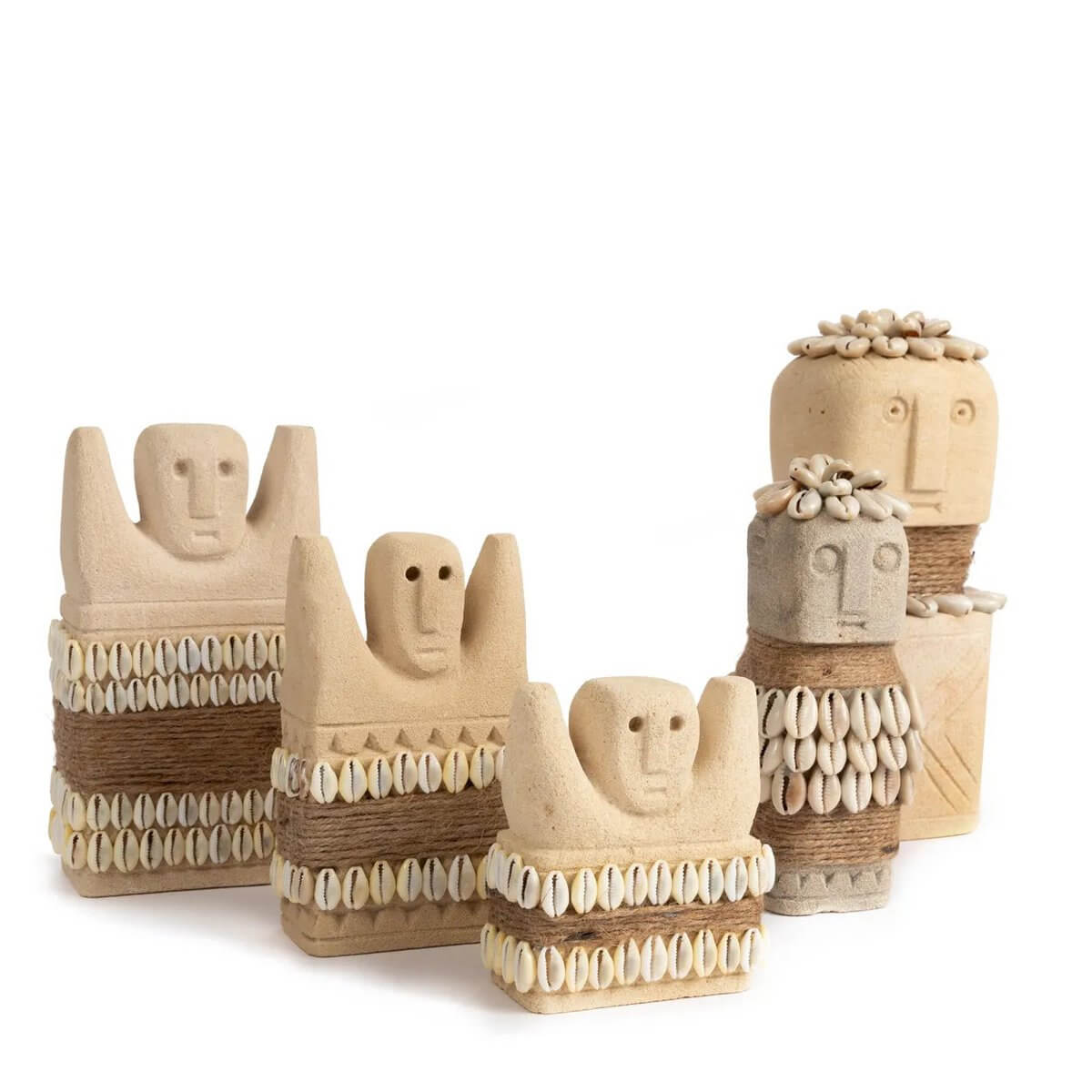 Bohemian Sumba stone statues from Indonesia, hand-carved sandstone figures adorned with shells, perfect for decor and protection.