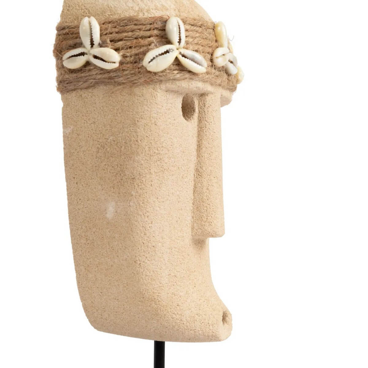 Hand-carved Sumba stone statue with cowrie shell detail on display stand, perfect for Bohemian decor.