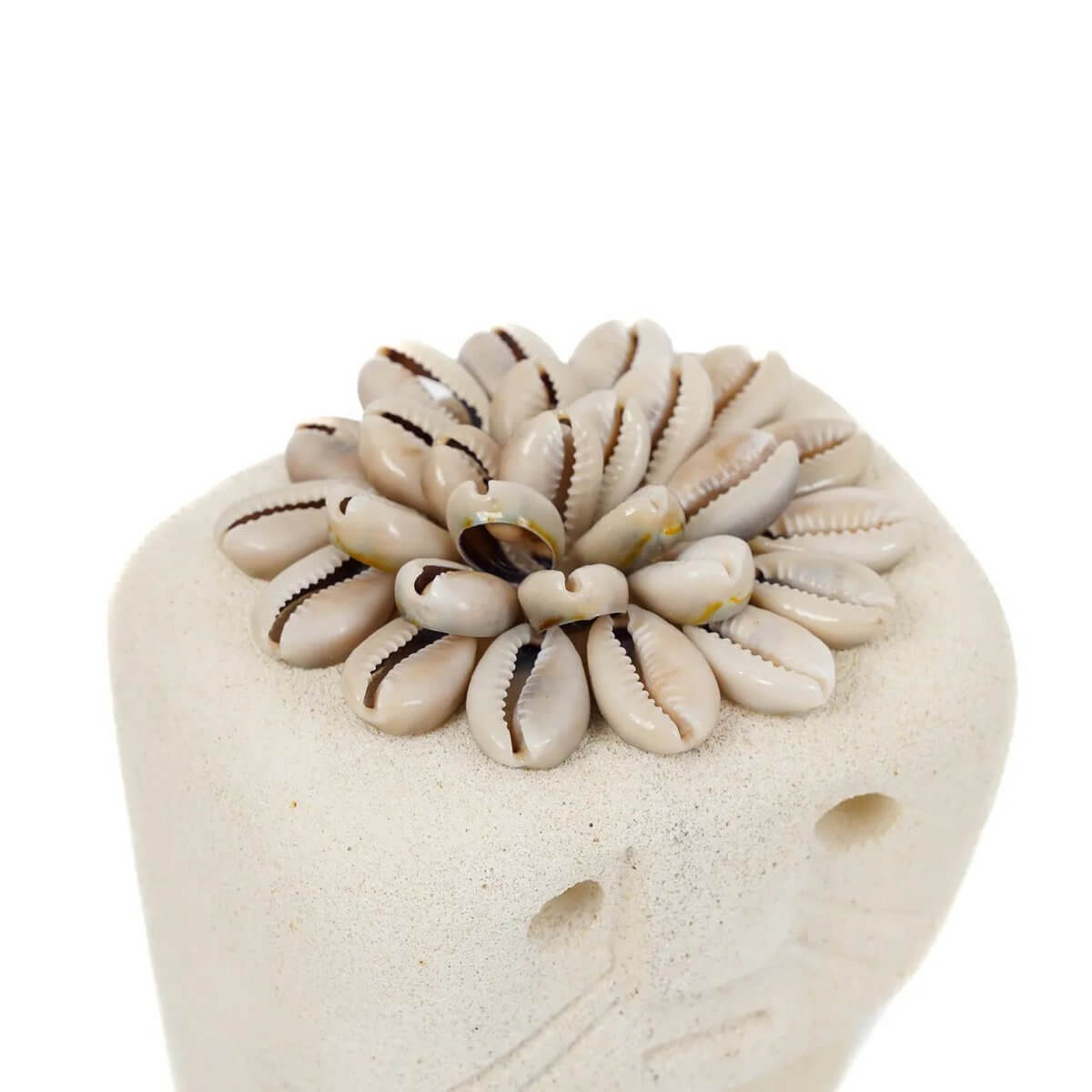 Hand-carved Sumba stone statue topped with shells, exuding Bohemian charm from Indonesia.