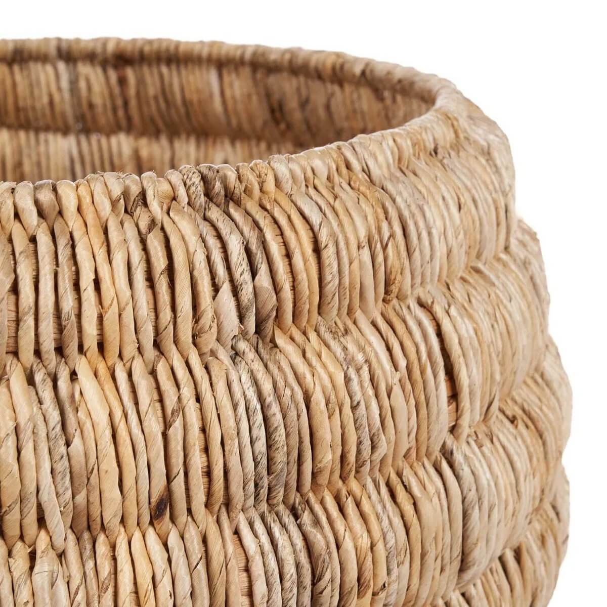 Close-up of the De Tatum Basket, a handwoven banana leaf basket with a bohemian style, showcasing its natural earthy tones and texture.