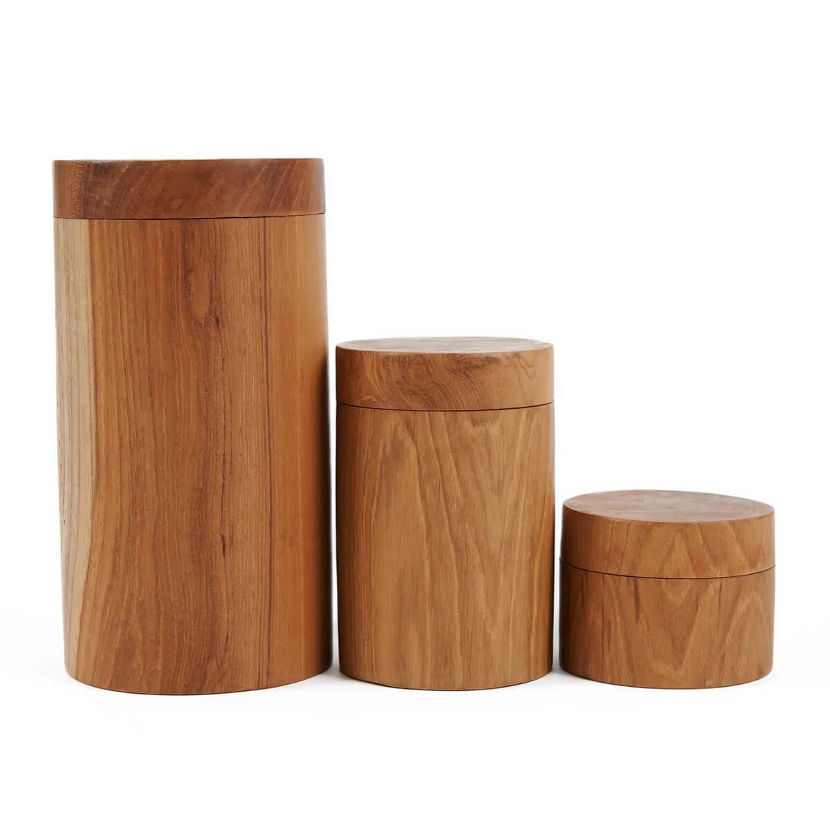 Three teak root jars in varying sizes with intricate textures, showcasing a bohemian charm, perfect for stylish storage solutions.