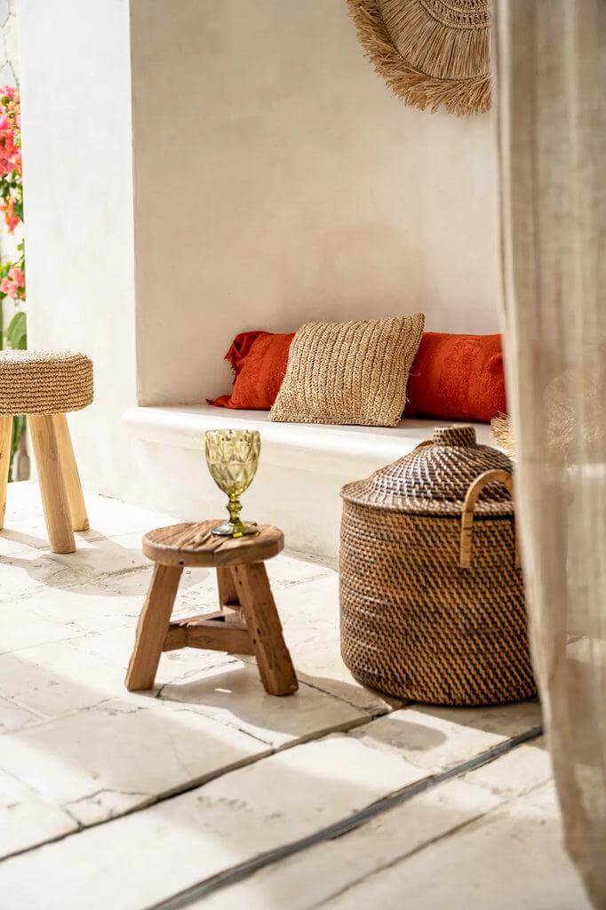 Gezellige kamer met Yatai kruk van upcycled teakhout, omringd door kussens en decoratieve elementen voor een warme sfeer.