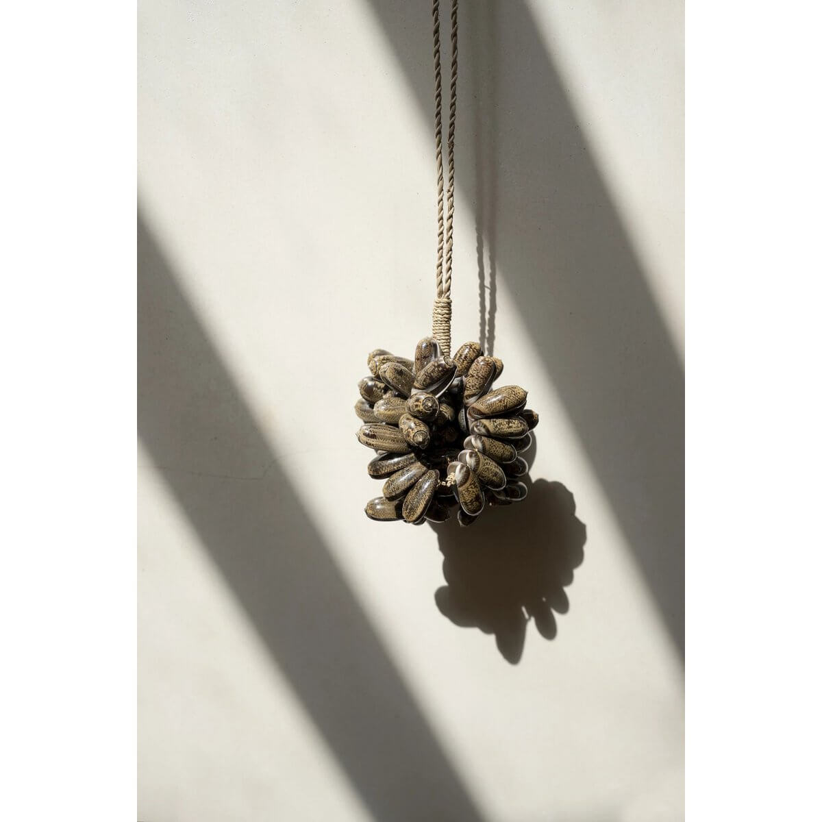 Exquisite brown kauri shell tassel by Bazar Bizar, adding bohemian flair to home decor with handmade Balinese craftsmanship.