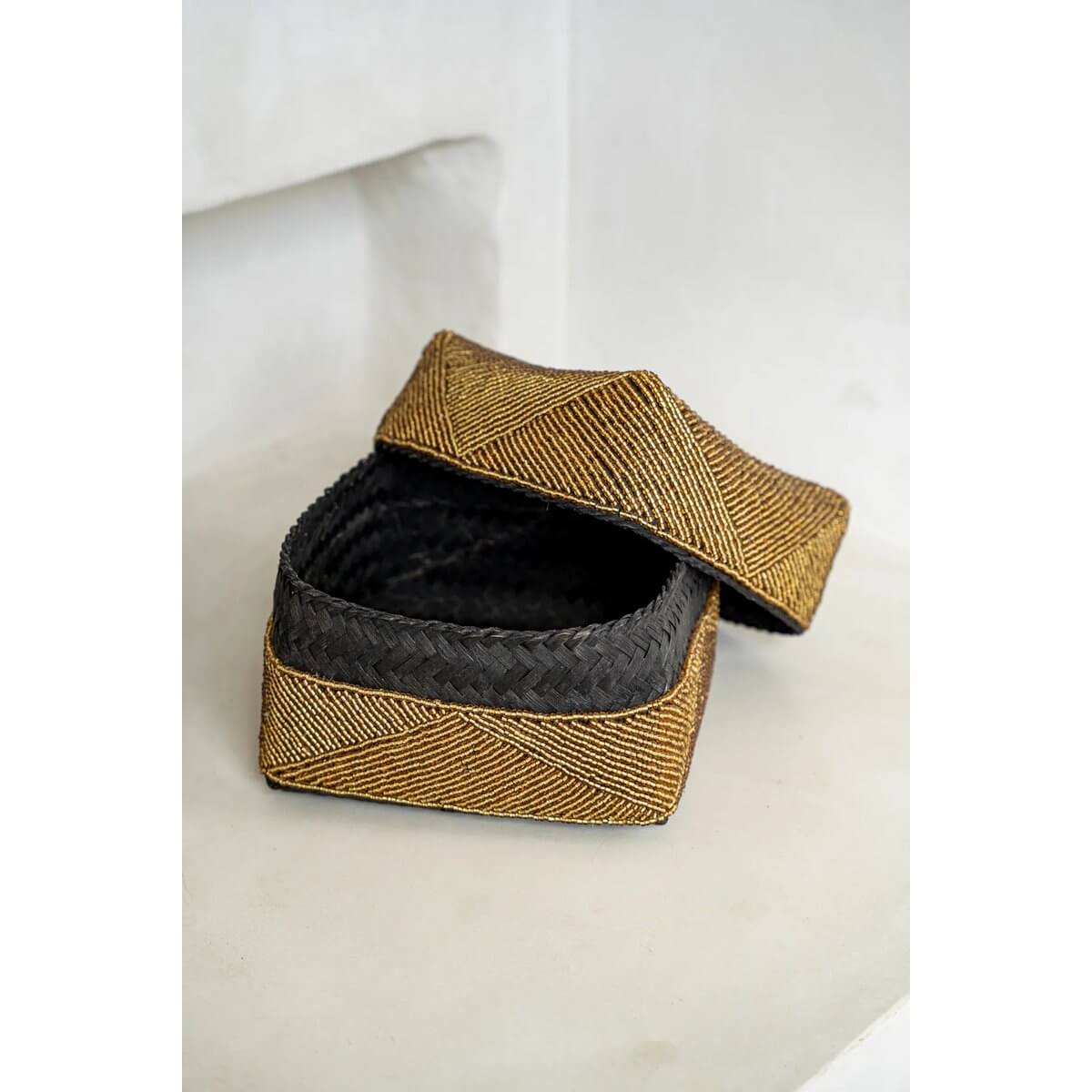 Bohemian gold beaded box handcrafted by Balinese artisans, perfect as storage or decorative piece, open with lid beside.