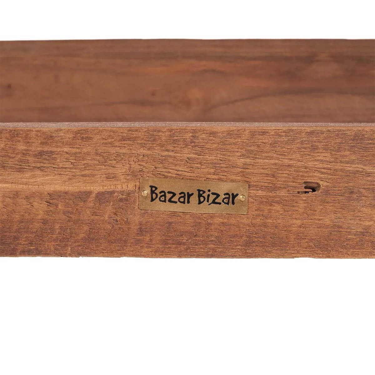 Close-up of a Bazar Bizar label on a teak wooden bench, showcasing the natural wood grain and rustic bohemian design. Perfect for chic interiors.