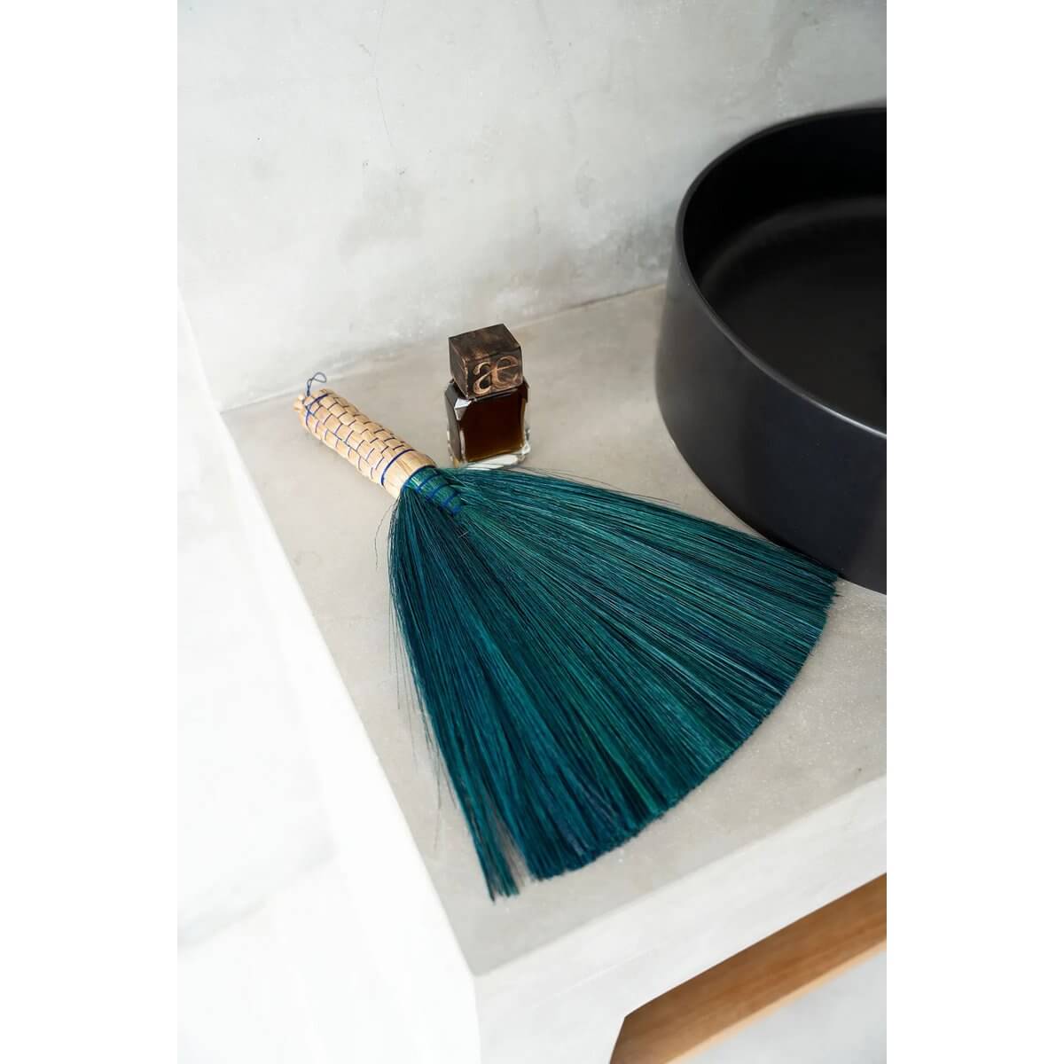 Alt Tag: Turquoise Bohemian hand broom from Indonesia, perfect for sweeping dust and adding style to your interior décor.