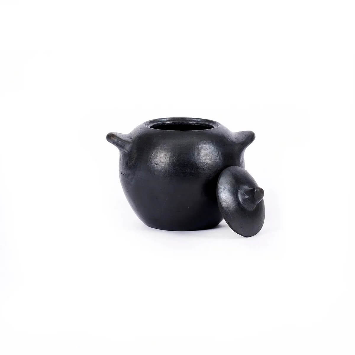 Black burned bohemian pot with lid, perfect for sugar or sauces. Stylish addition to any table setting.