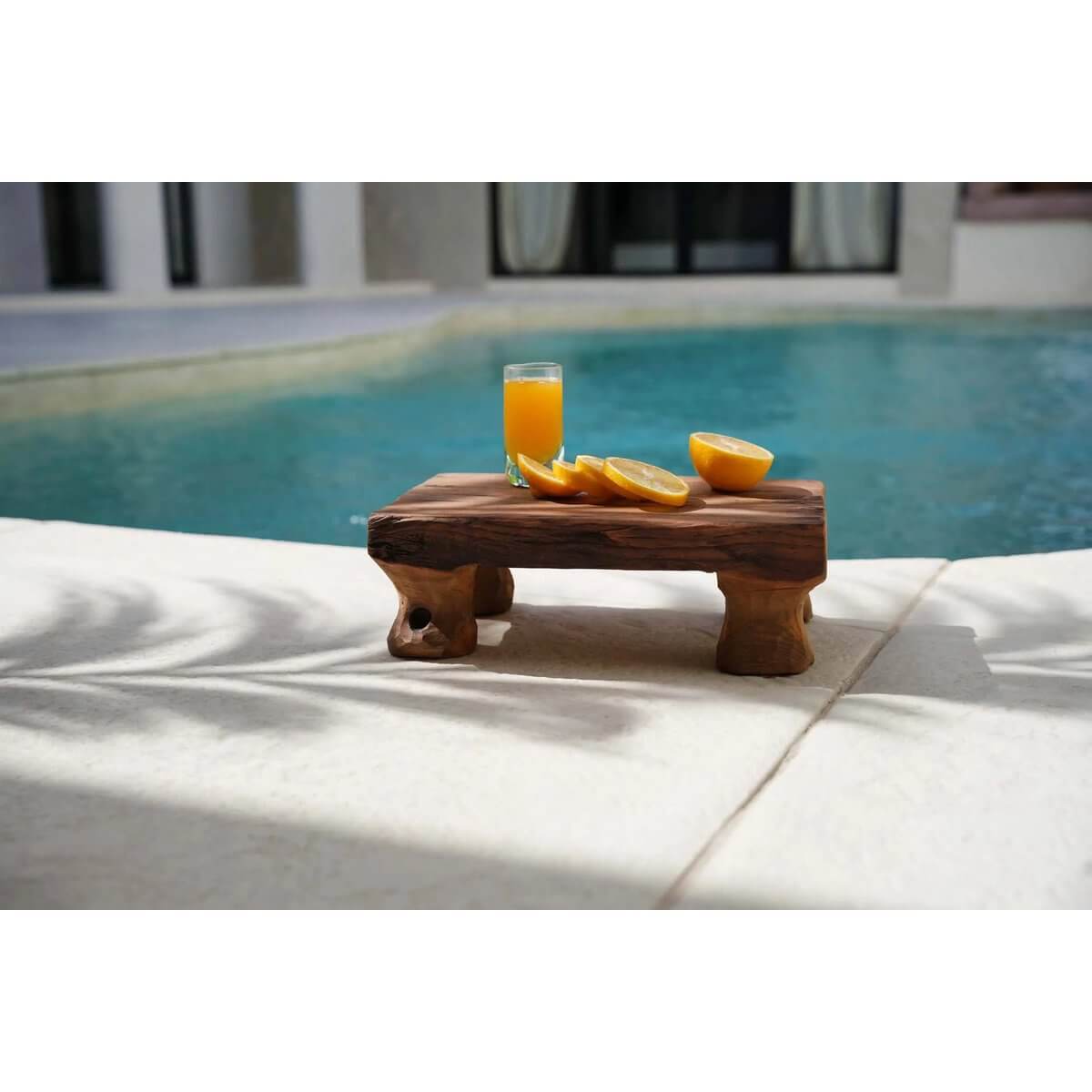 Bohemian Tray by the Pool: The Delish Tray in teakwood with orange slices and juice, perfect for stylish snacking.