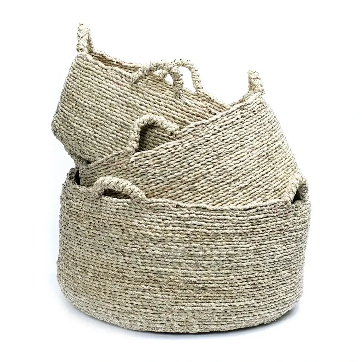 Set of natural sea grass woven Quatre Mains baskets with four handles, perfect for modern or boho chic interiors, ideal for storage.