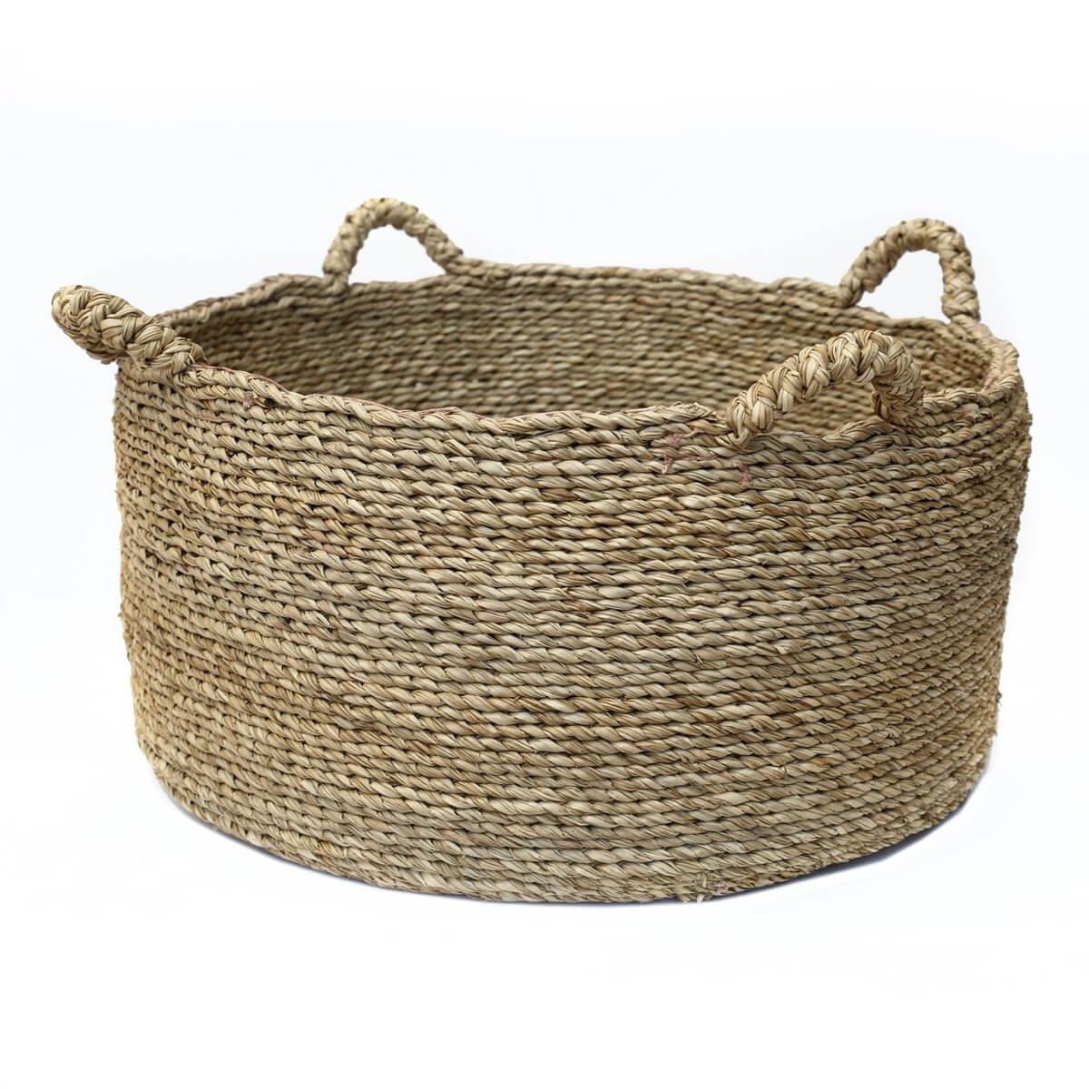 Sea grass woven Quatre Mains basket with four handles, perfect for laundry, towels, or toys in modern and boho chic interiors.