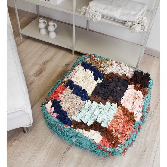 Marokkaans Boucharouite vloerkussen in levendige kleuren, handgemaakt van gerecycled textiel, voegt sfeer toe aan elke ruimte.