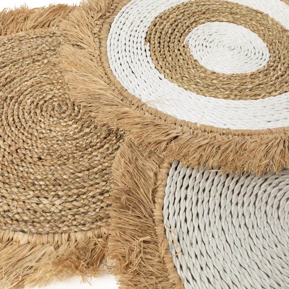 Raffia en zeegras placemats in wit en natuurlijke tinten, ideaal voor boho- en kustinterieurs, binnen en overdekt buiten te gebruiken.