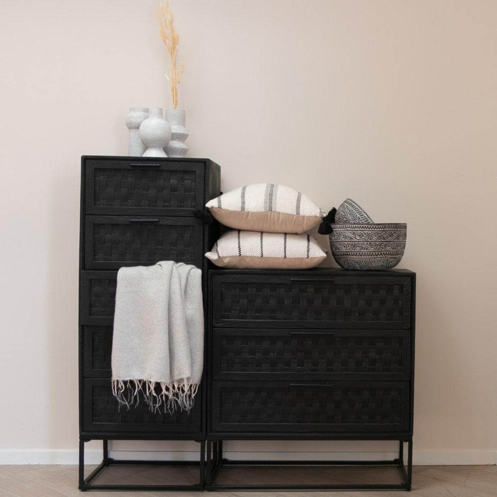 Decoratieve kastjes met kussens en manden in moderne woonkamerinrichting.