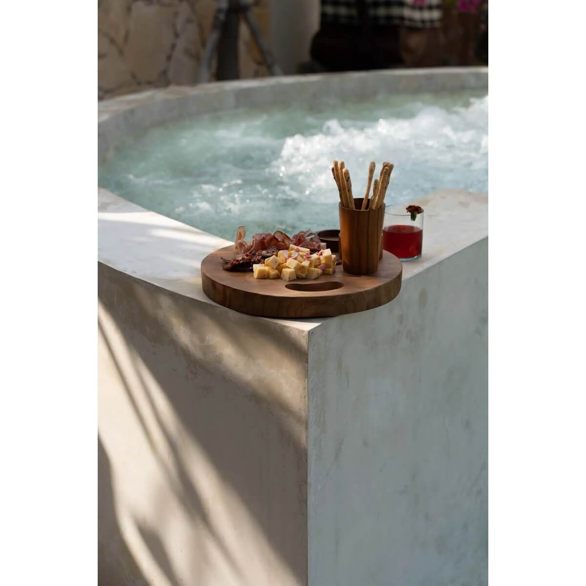 Bohemian Teak Root Cup by the hot tub, with a platter of snacks, adding organic elegance to outdoor relaxation scene.