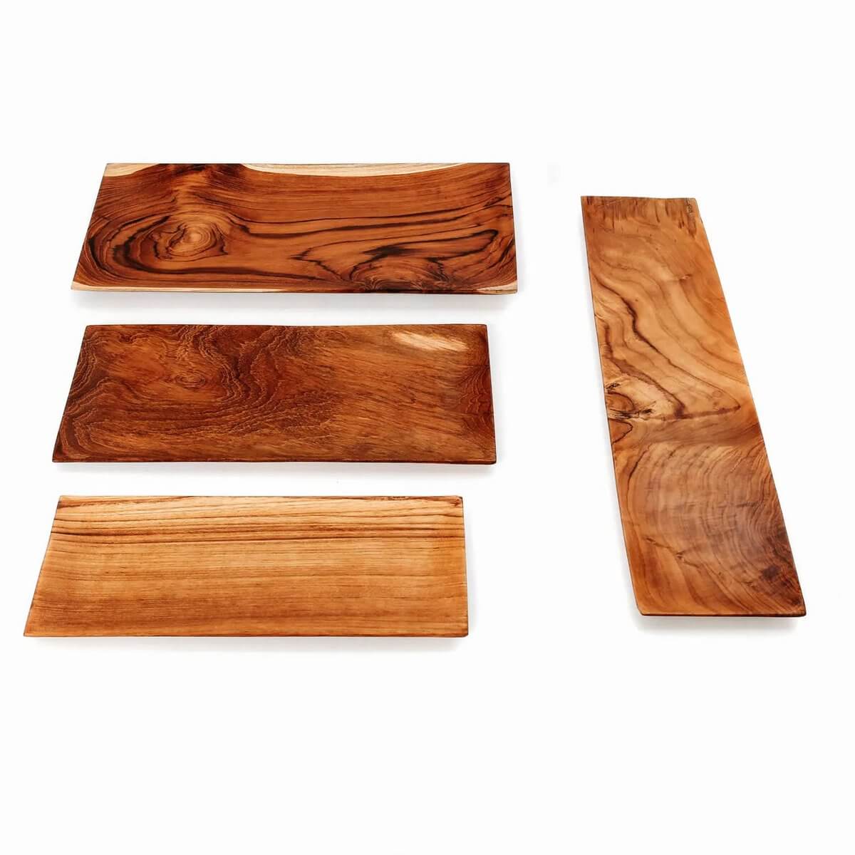 Four elegant teak root sushi plates with natural wood grain, perfect for a Bohemian dining decor.
