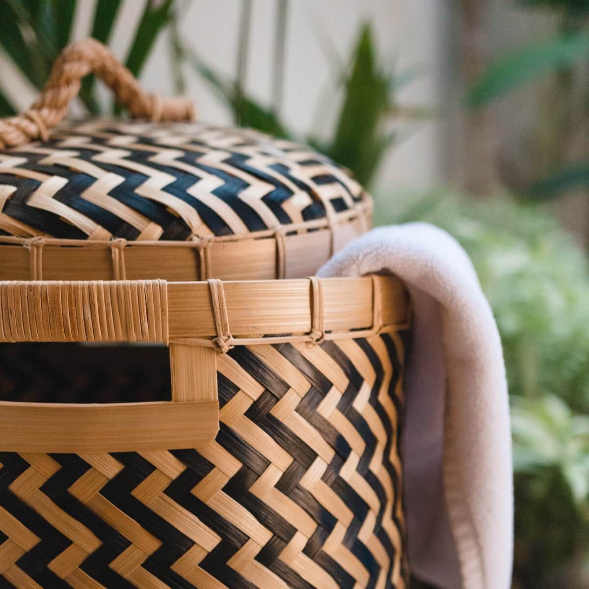Tweekleurige bamboe wasmand Nabire met deksel, duurzaam handgemaakt ontwerp, ideaal voor wasgoed, met praktische handgrepen.