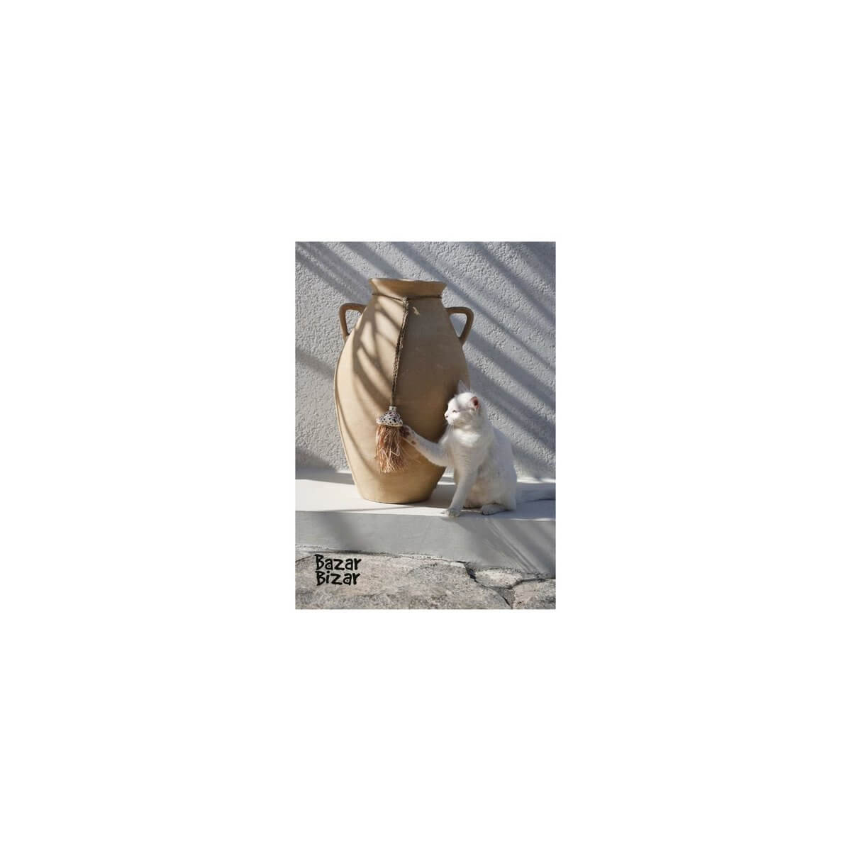 Bohemian vase with tassel decor and curious cat, featured in Bazar Bizar's 2025 luxurious catalog.
