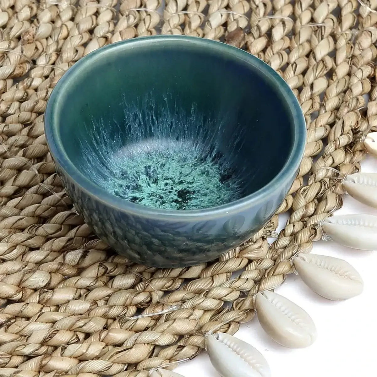 Stylish De Aqua Sauce Bowl XS on woven mat, perfect for serving dips and sauces elegantly; part of a cohesive table setting.