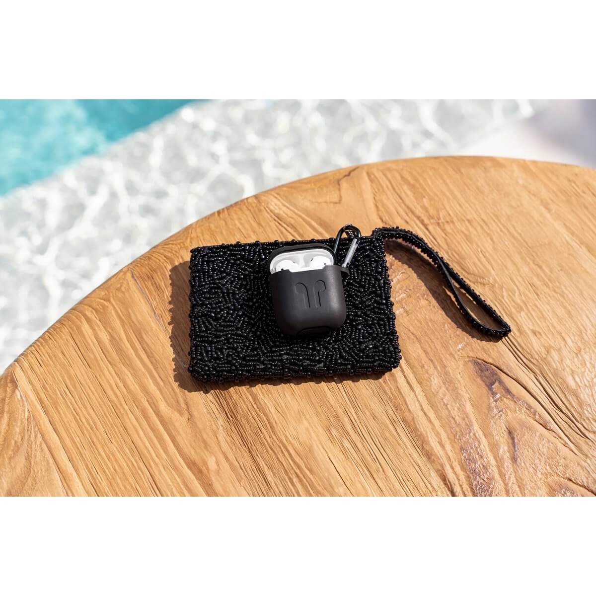 Bohemian Black Pearl Wallet displayed on a wooden table by the pool, with elegant, compact design for effortless style.