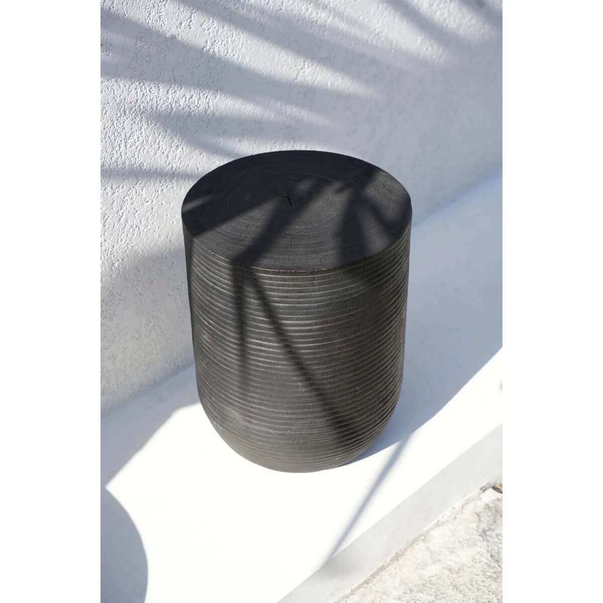 Black suar wood stool with Bohemian style and sleek finish, perfect for seating, side table, or decor accent.