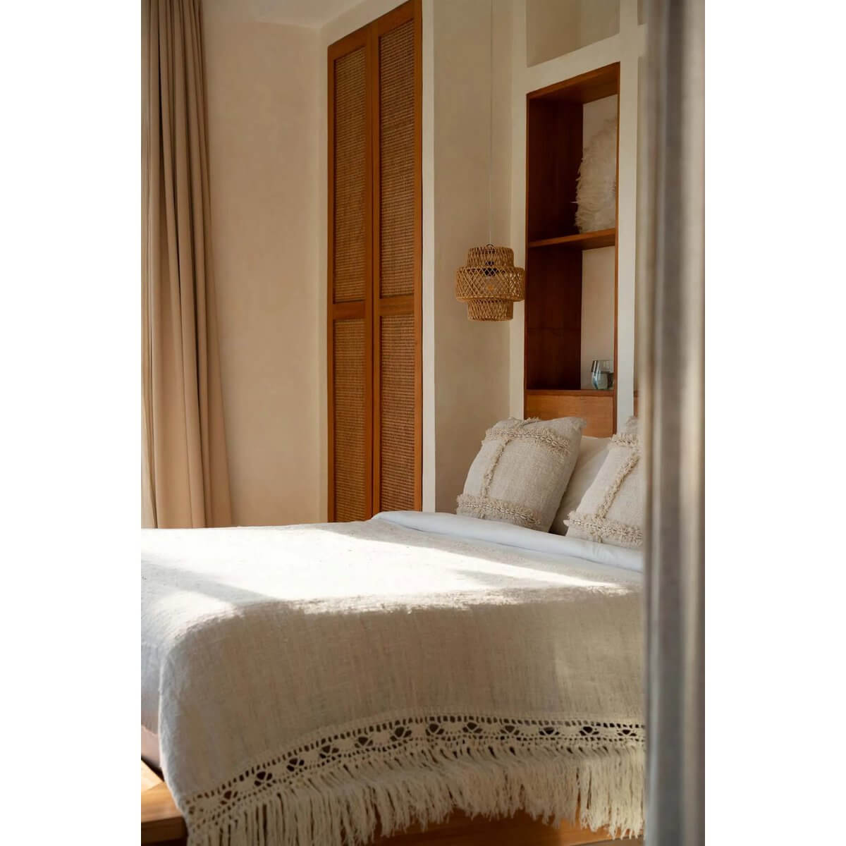 Elegant bedroom with Gypsy Bedsprei in natural tone, featuring bohemian fringe detail for a cozy, stylish look.