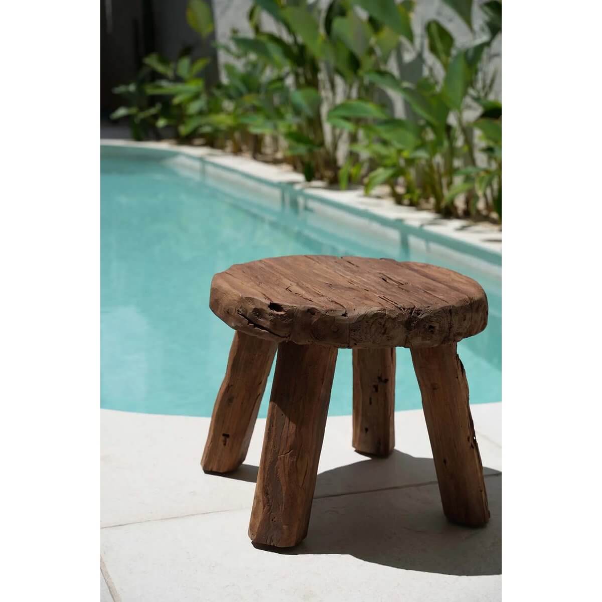 Rustic De Marabunta side table in natural wood by poolside, showcasing bohemian charm and earthy vibes.