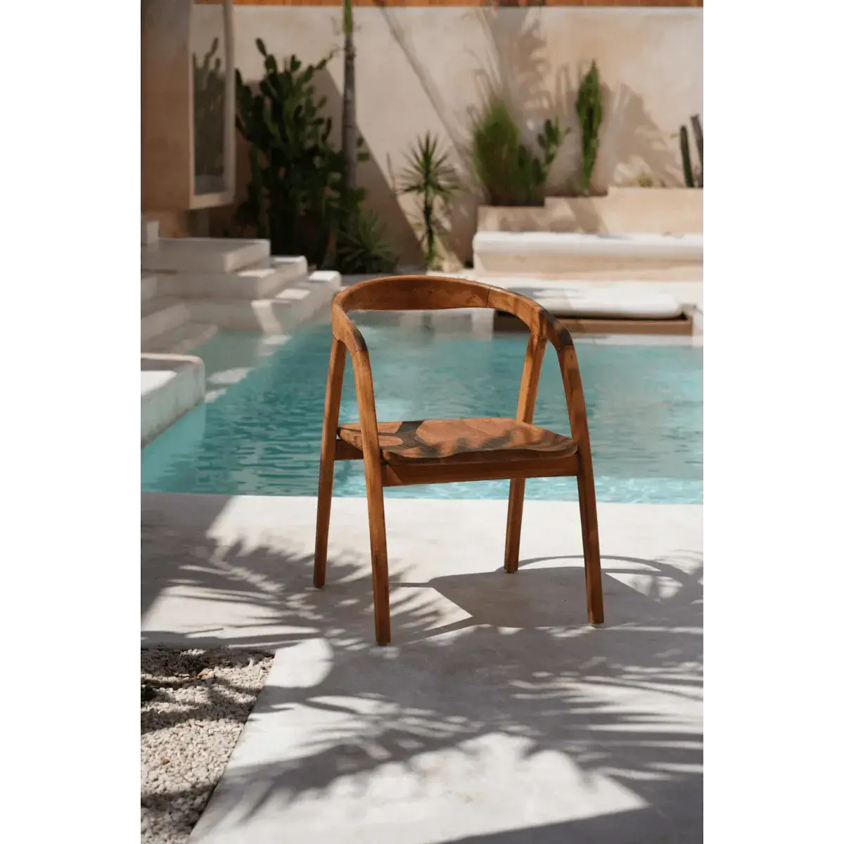 Bohemian style De Nihi Watu dining chair by Bazar Bizar Living, 55cm width and length, by a pool with a tropical vibe.