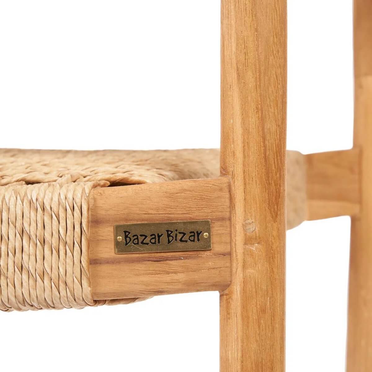 Close-up of woven seat and wooden frame on a bohemian-style chair, featuring a natural finish with a "Bazar Bizar" label.