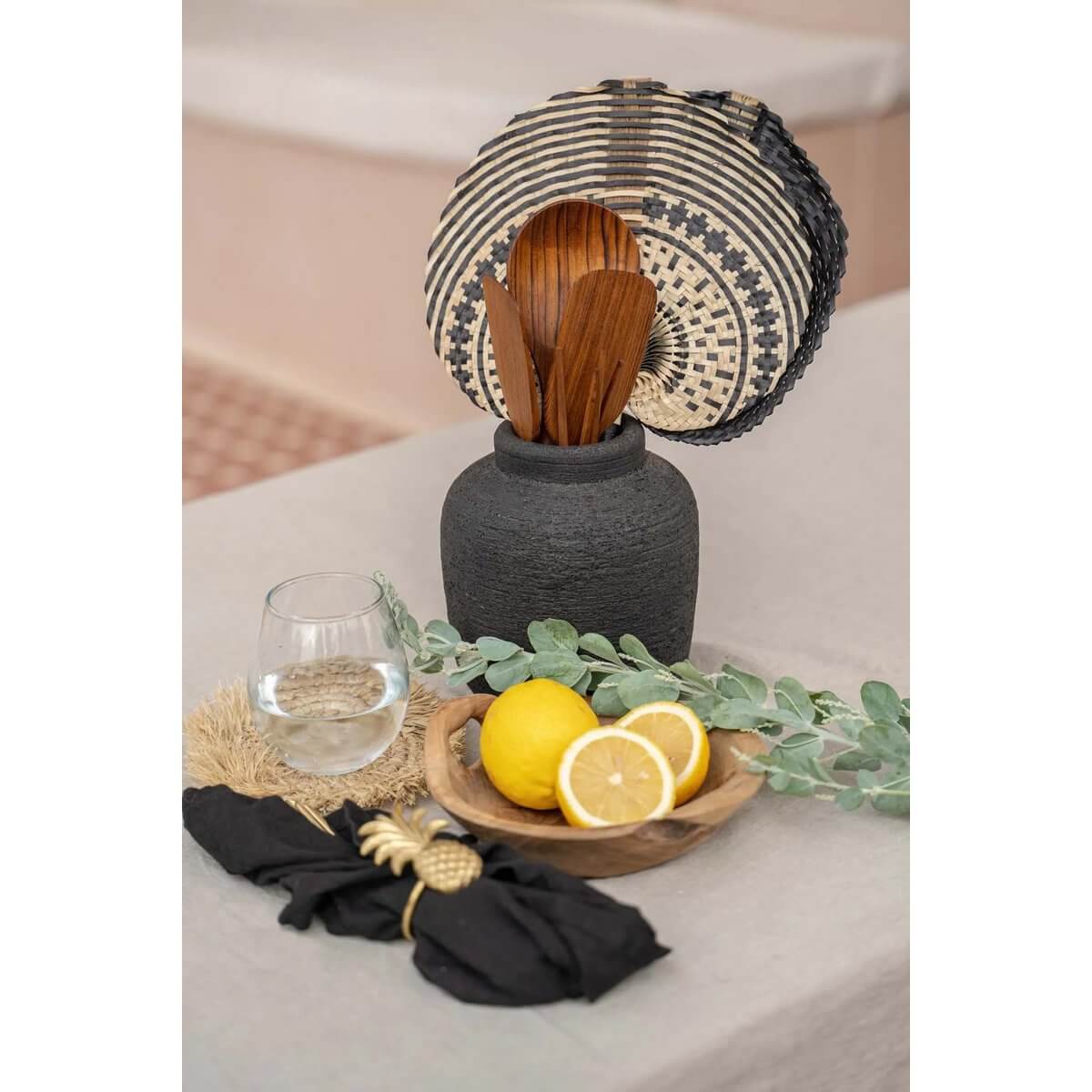 Bohemian charm: Black Peaky Vaas holding wooden utensils, in a cozy, rustic setting with lemons and eucalyptus accents.