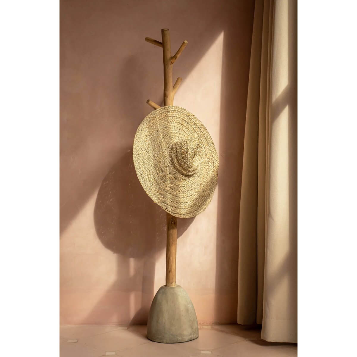 Bohemian De Playa hat made of 100% water hyacinth hanging on wooden rack, perfect for summer elegance and comfort.