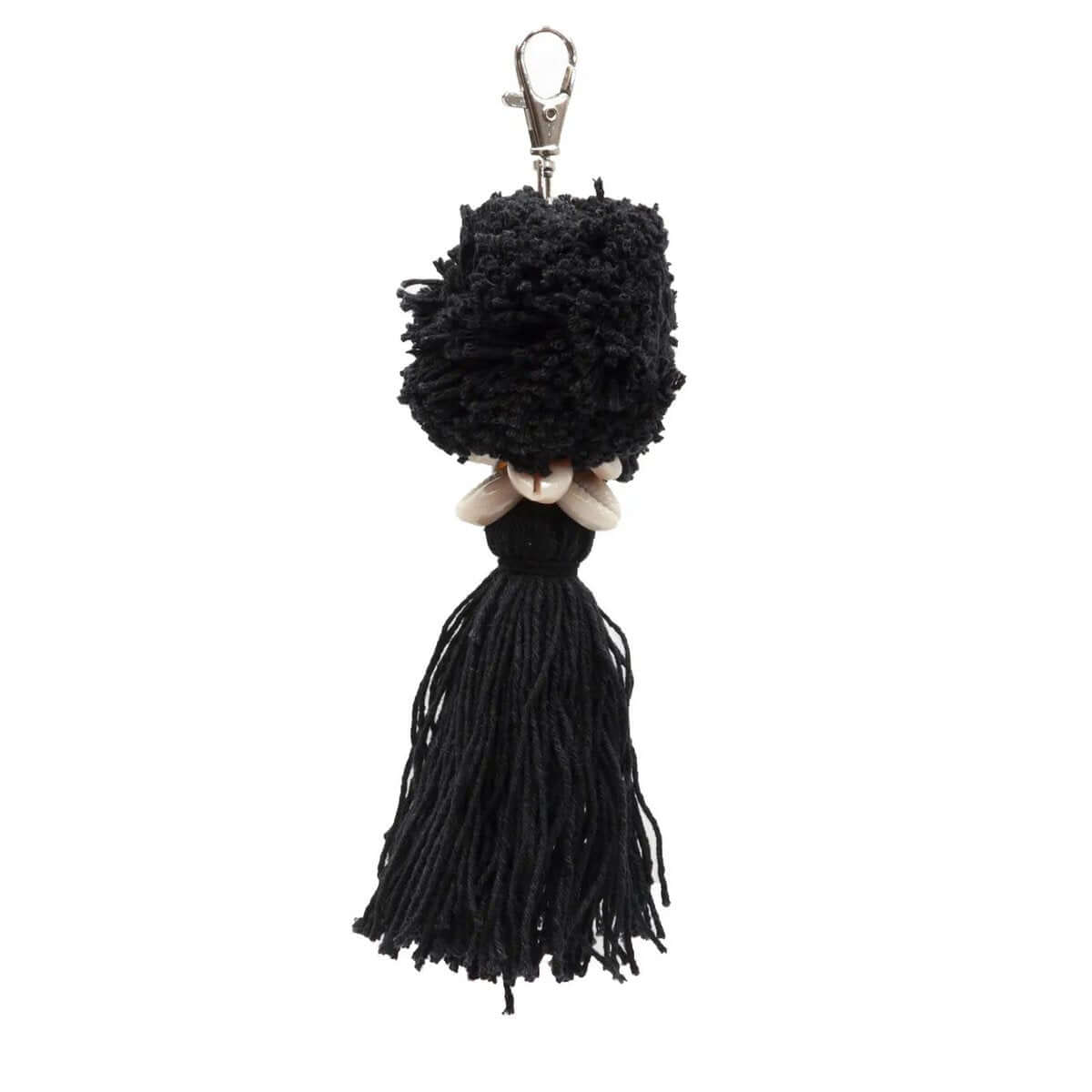 Charming black pompom keychain made of soft cotton, adding a Bohemian touch to your keys, bag, or backpack with its playful design.