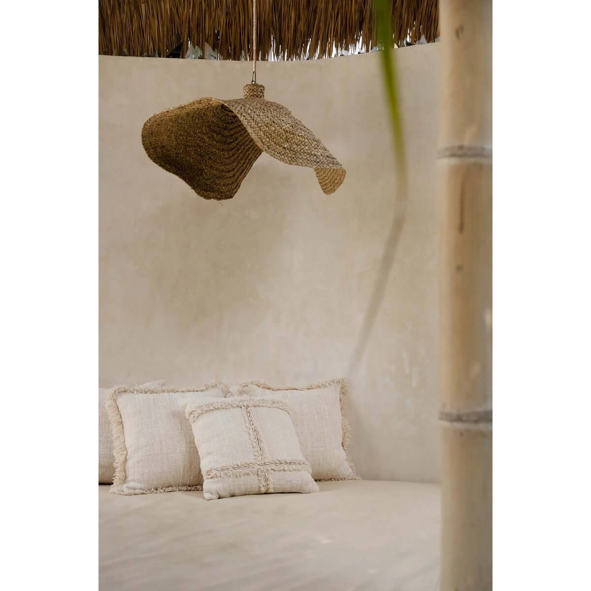 Bohemian-inspired De Qubba Hanger in XL, made from woven water hyacinth, creating cozy light patterns in a room for a natural look.