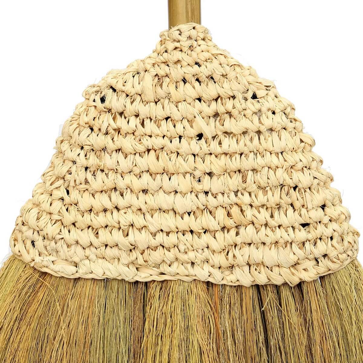 Handmade bohemian broom crafted from natural Indonesian fibers with a charming twine loop for decorative indoor use.
