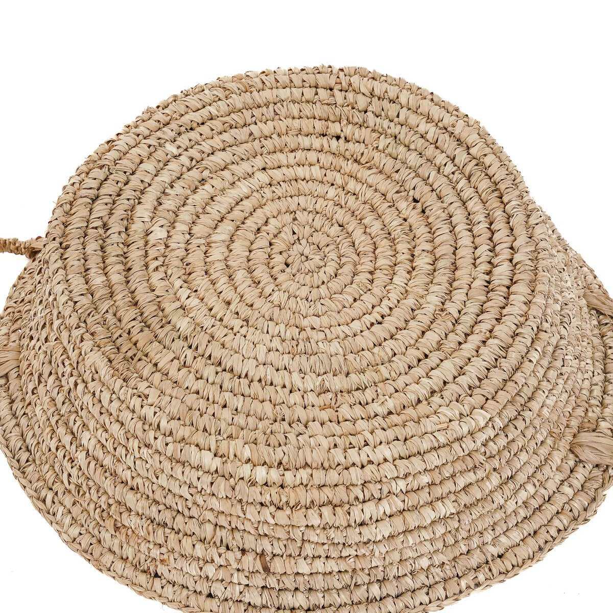 Bohemian-style raffia basket with natural woven texture, perfect for adding rustic elegance to small spaces and storage options.